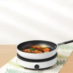 اجاق القایی شیائومی نسخه لایت | Mi Induction Cooker Lite با طراحی مدرن، تنظیم 9 سطحی دما و توان 2100 وات، انتخابی مناسب برای پخت و پز سریع و ایمن است.